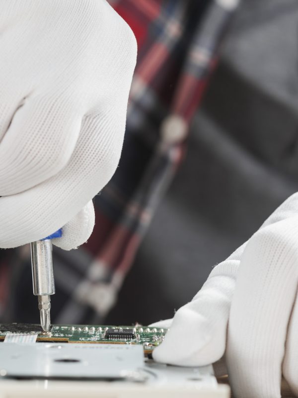 technician-repairing-computer-motherboard-with-screwdriver